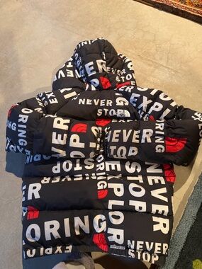 The North Face Black Puffer Jacket with White Text & Red Logos